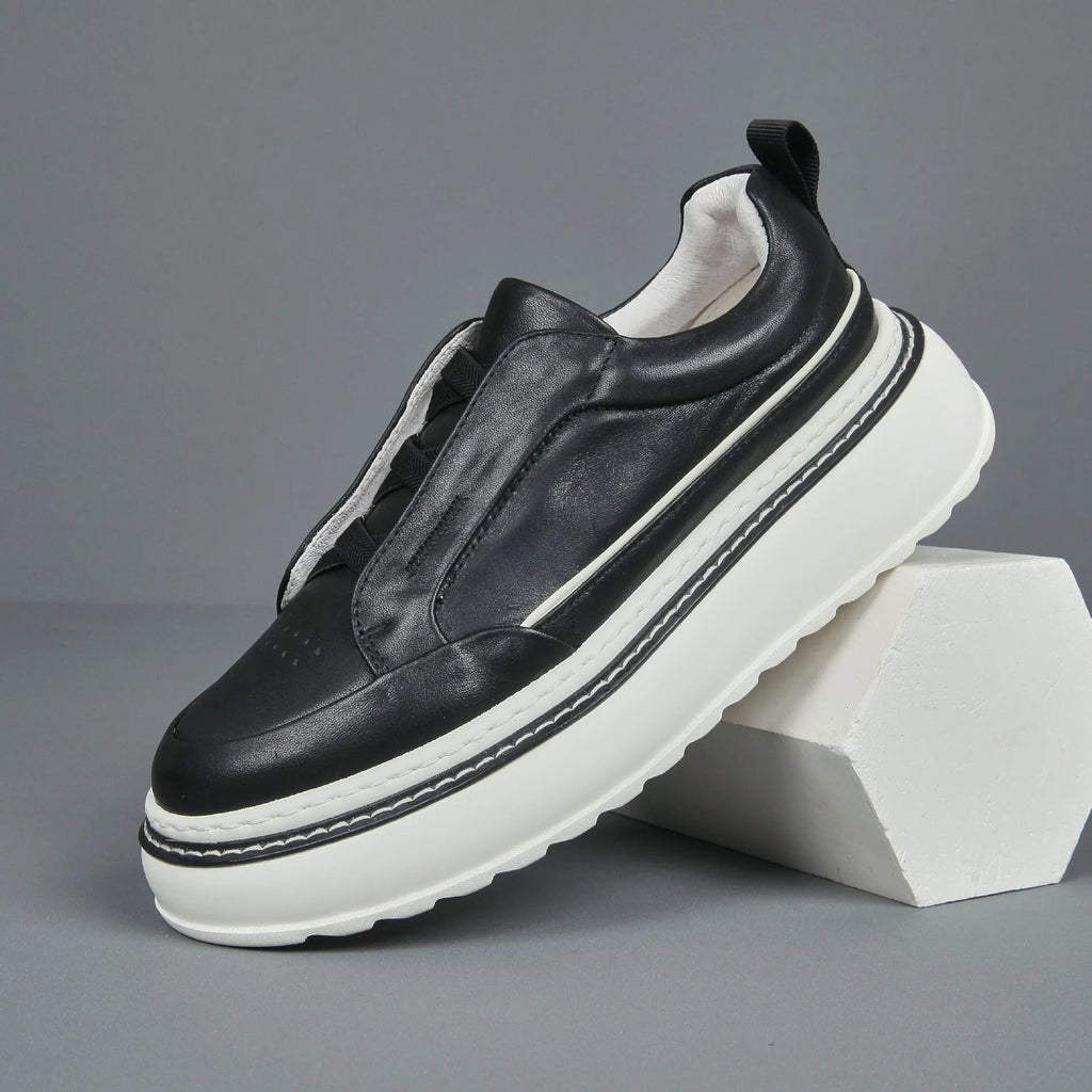 Women's black casual slip-on sneaker with cowhide upper, foam platform sole, round toe, and elastic band