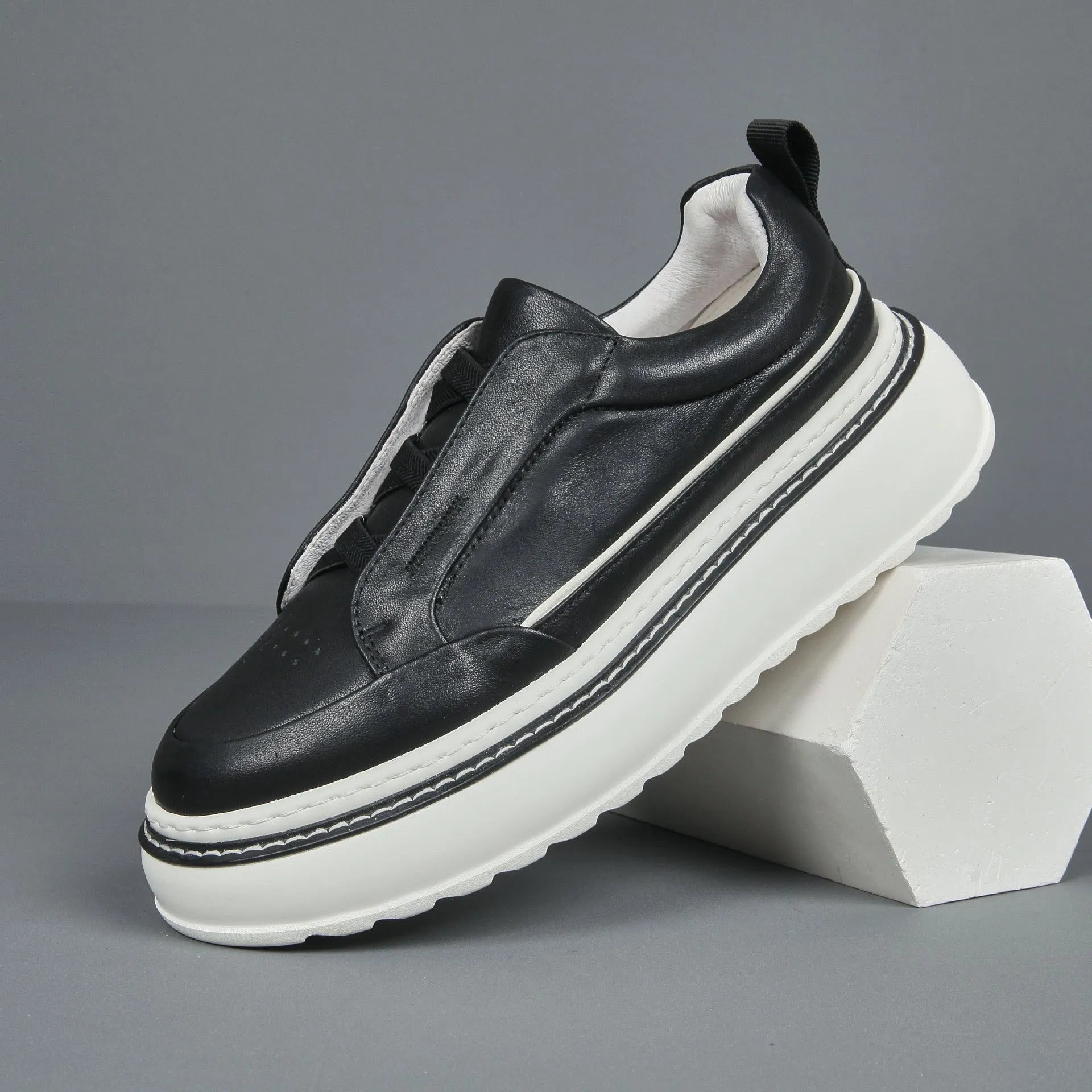 Women's black casual slip-on sneaker with cowhide upper, foam platform sole, round toe, and elastic band