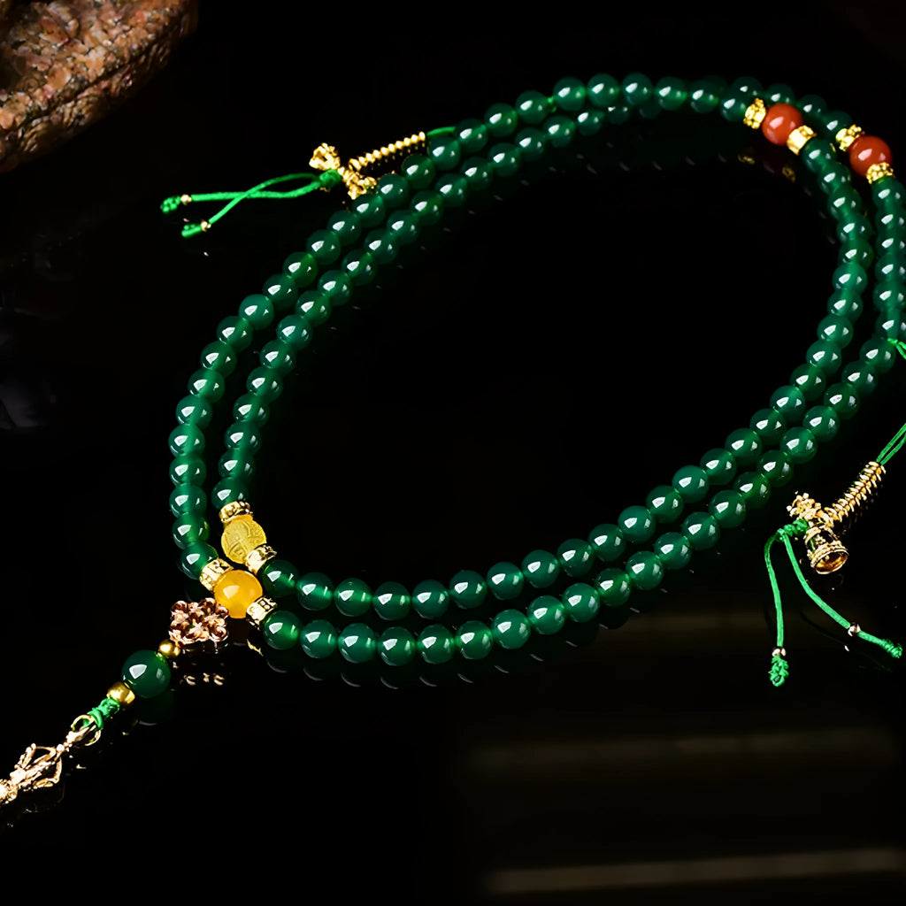 Close-up of a multi-circle green agate bracelet with natural stone beads on a wrist.