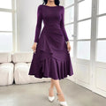 Purple women's long sleeve dress with round neck, mid waist, and ruffle detailing on a hanger.