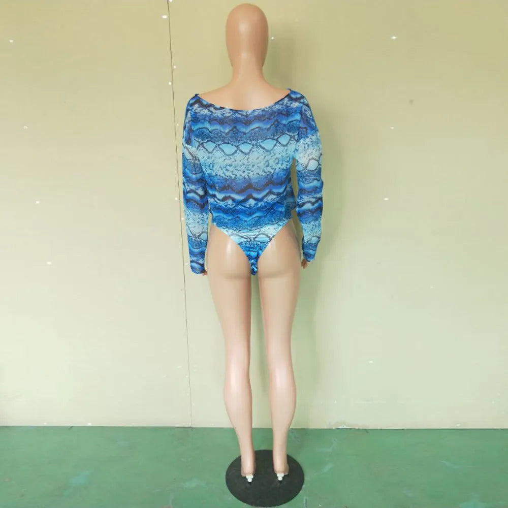 Women's purple snakeskin print bikini set with sleeveless top and shorts on a mannequin.