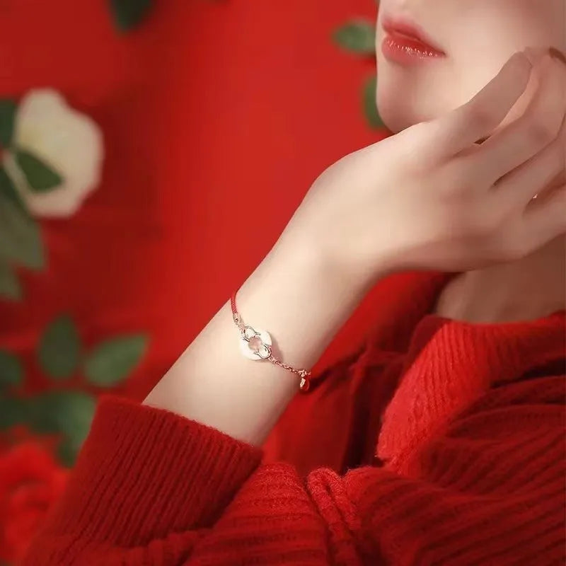 Festive koi bracelet with red rope design and peace buckle closure
