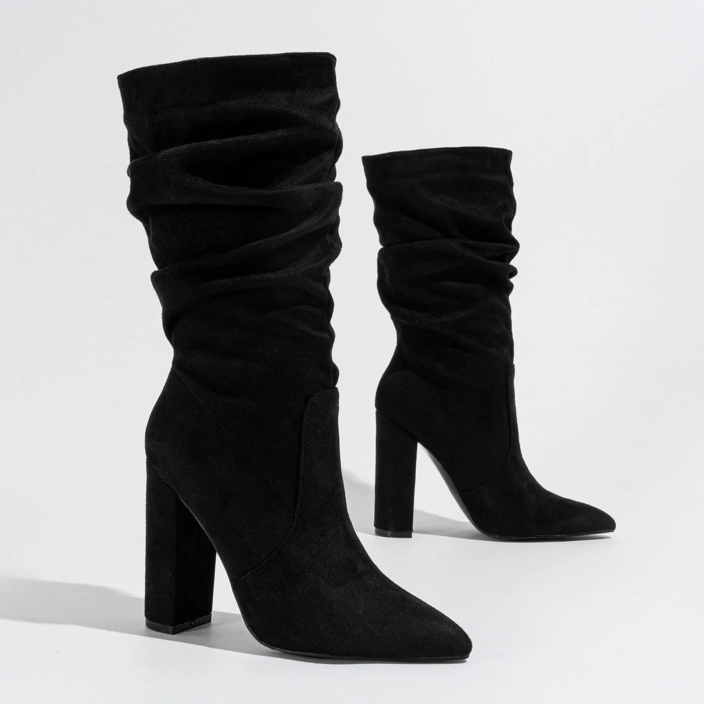 Women's black suede chunky heel pointed toe boots with a mid-calf length.