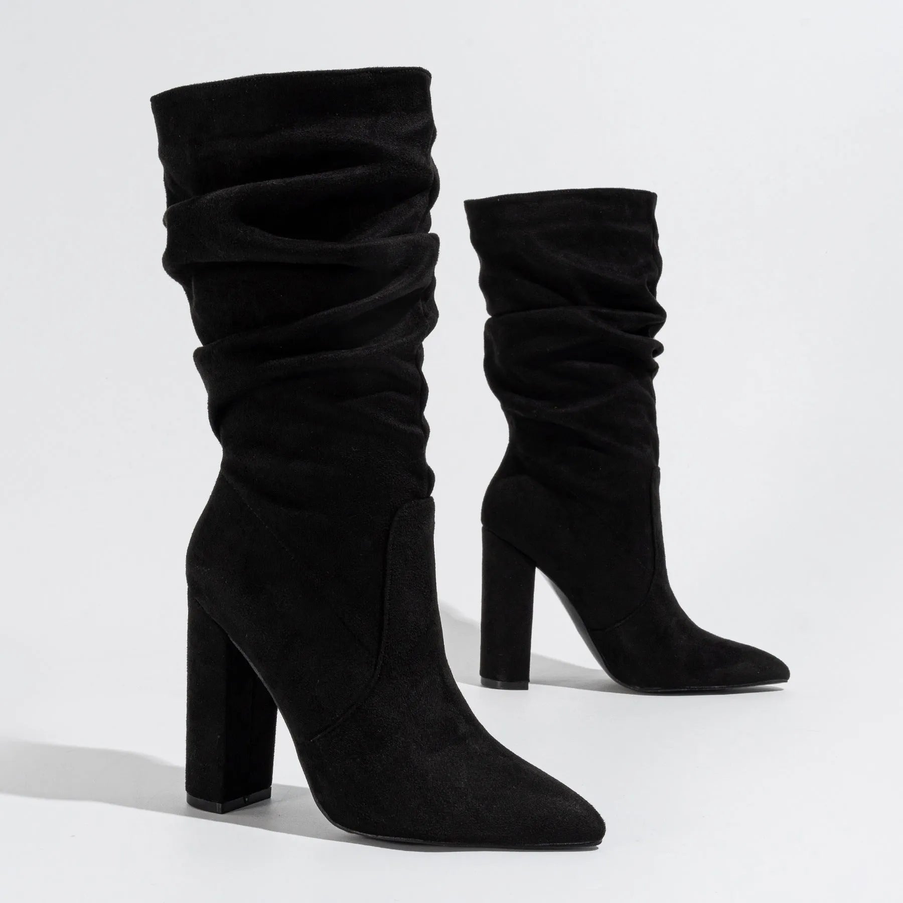 Women's black suede chunky heel pointed toe boots with a mid-calf length.