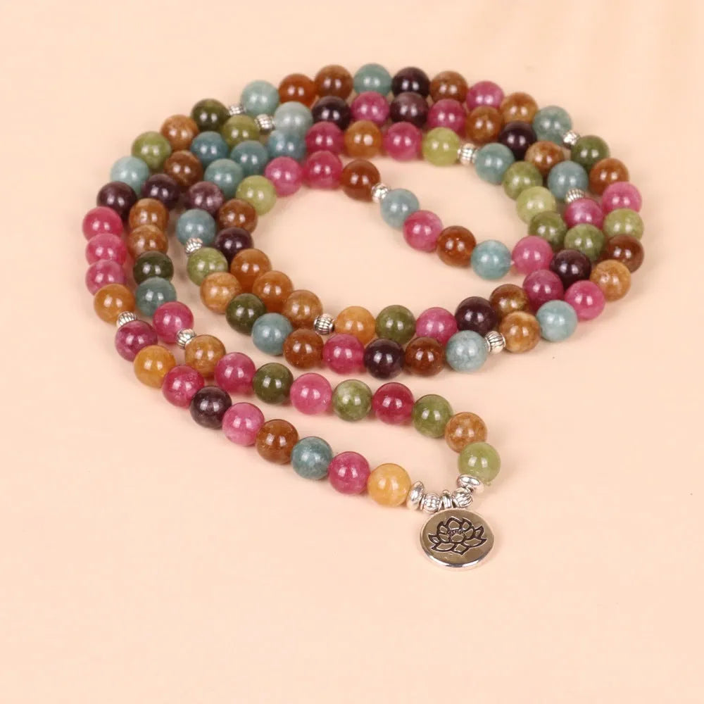 Tourmaline-colour alloy bracelet with 108 beads in a lotus string design laid flat