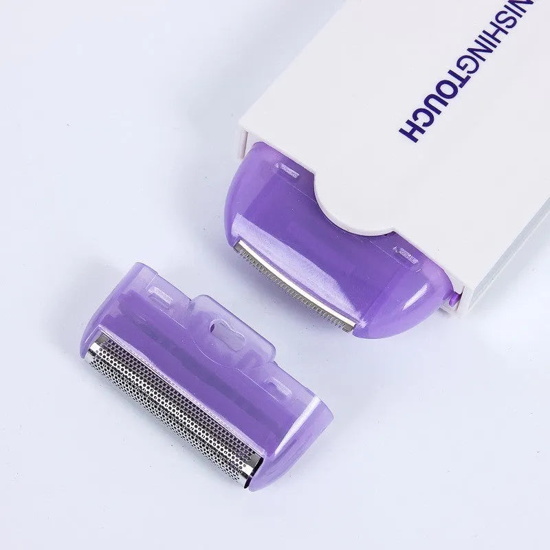Silver electric hair removal shaver with USB charger cord, trimmer head, foil head, and cleaning brush on a white background.