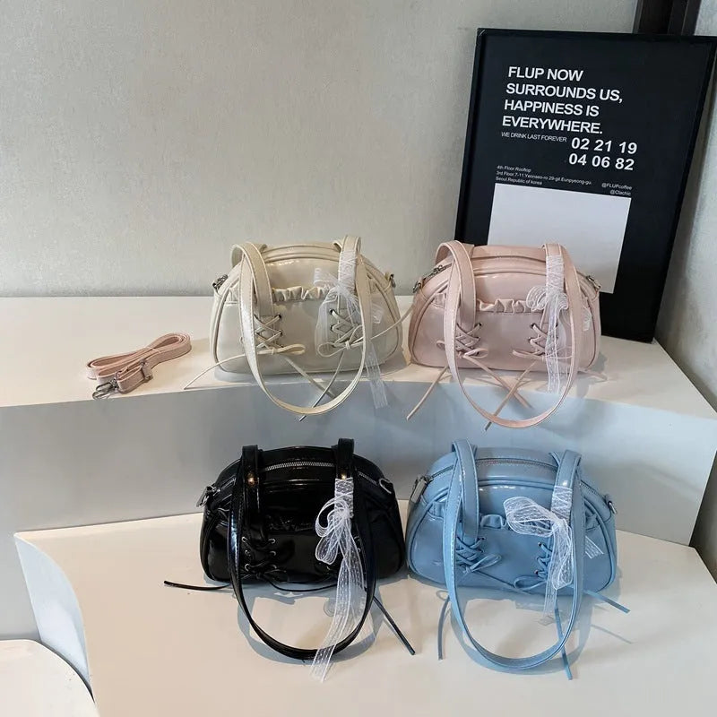 Women's PU leather handbag with bandage bow detail showing internal mobile phone pocket
