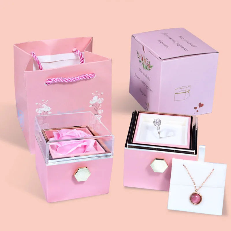 Rotating rose jewellery gift box with acrylic transparent cover showing preserved rose and rotating drawer open.