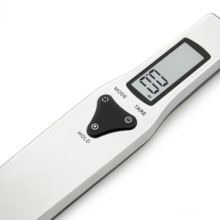 Smart digital kitchen measuring spoon with LCD display showing weight measurement.