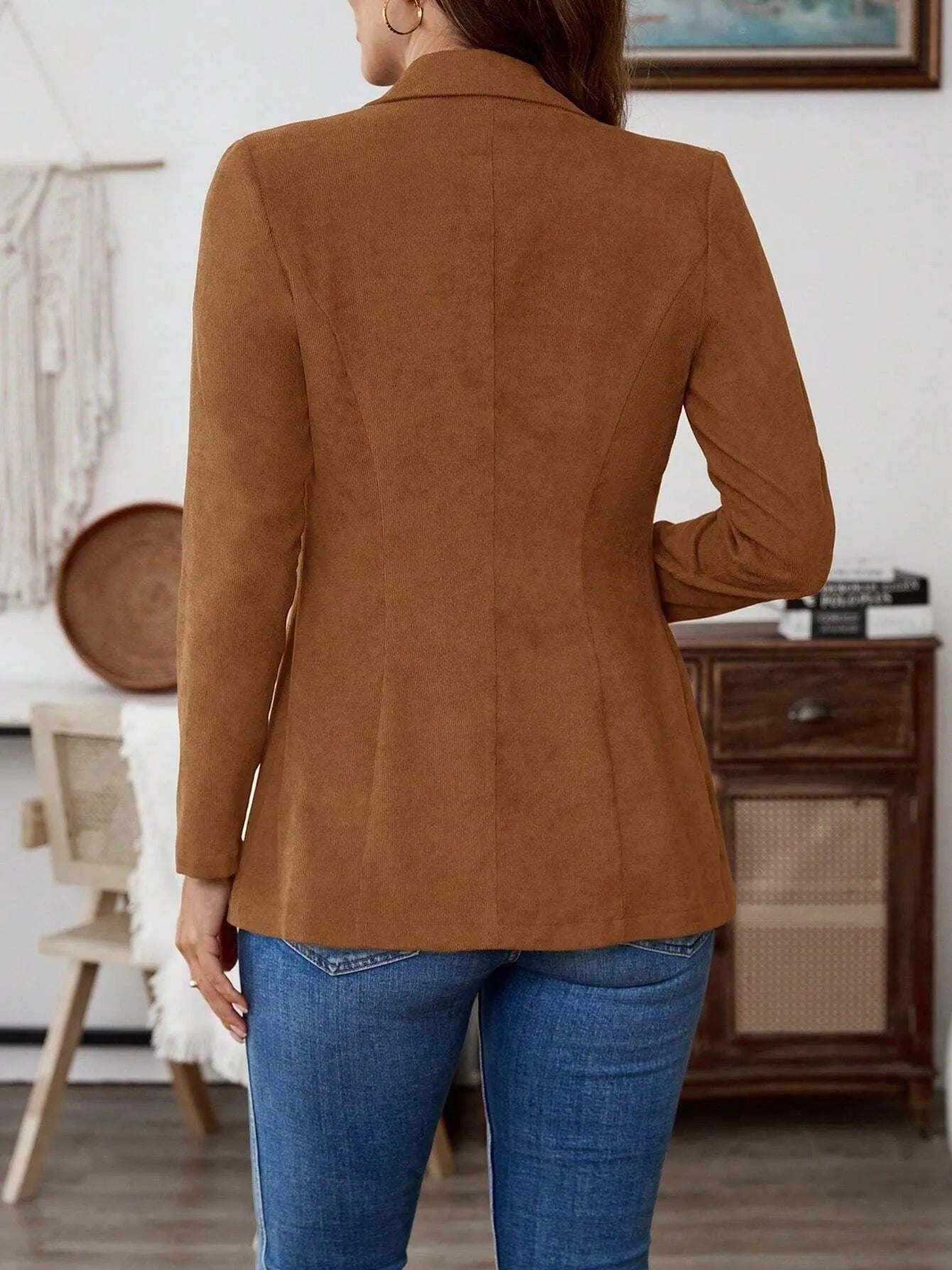 Brown single-breasted men's suit blazer with notch lapels on hanger