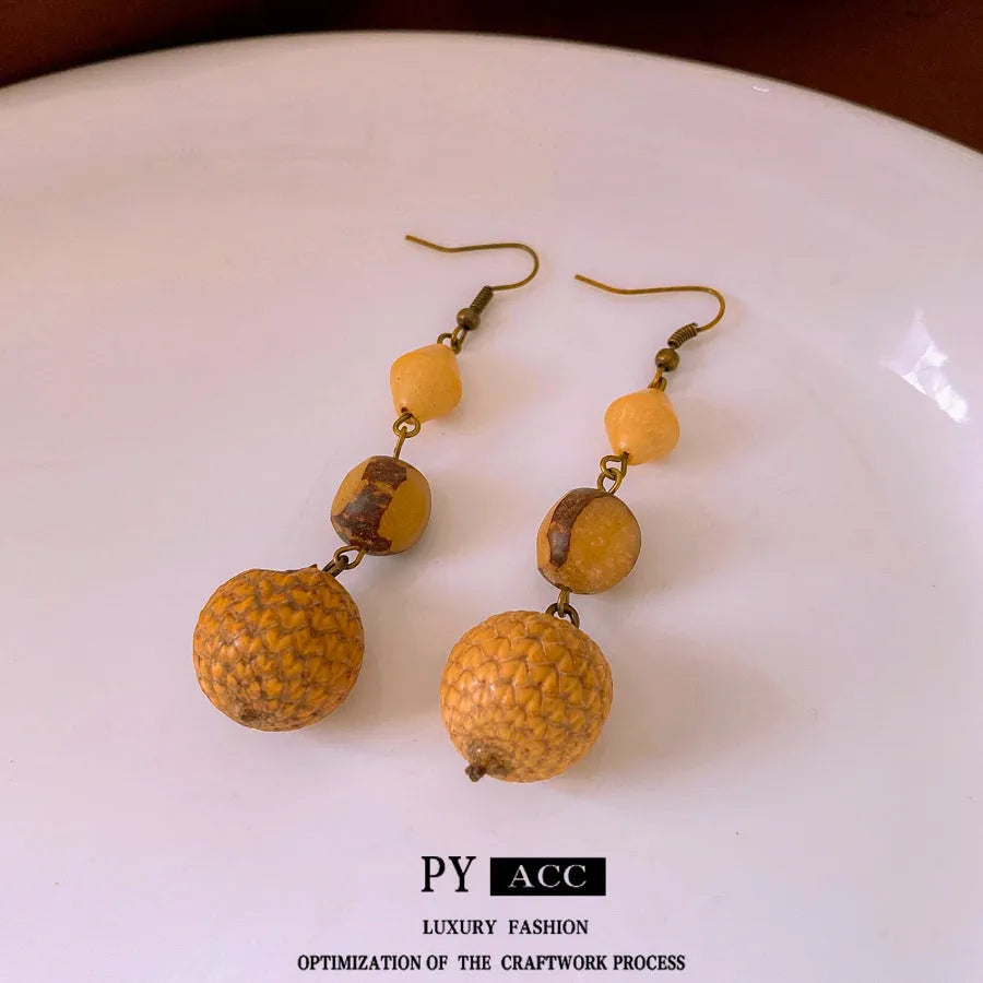 Brown resin fruit core tassel earrings with round geometric design and ear hook clasp for women