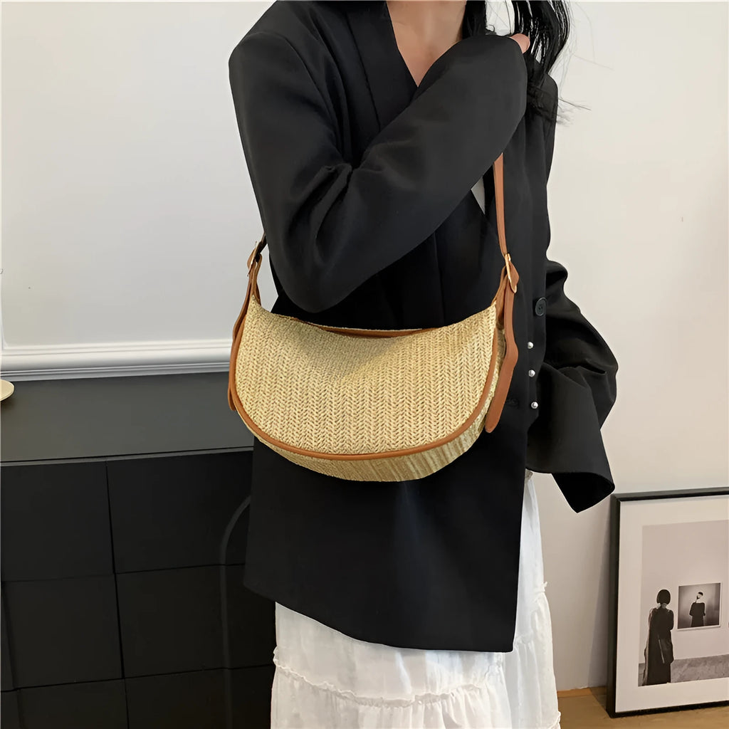Women's woven straw crossbody bag showing textured surface with phone and file compartments inside