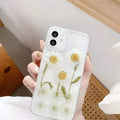 White TPU iPhone case with epoxy daisy floral design on back, shown fitted to a phone