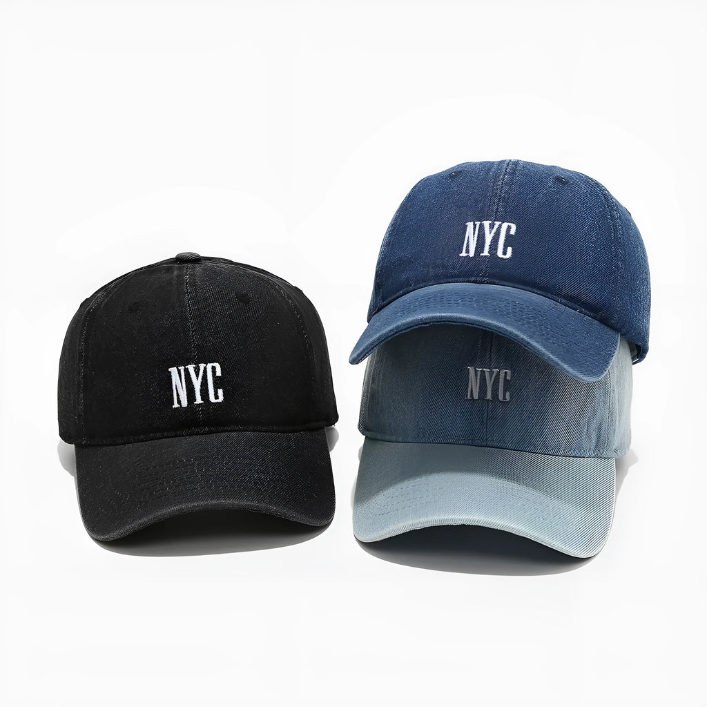Retro style denim peaked cap with a large alphabet letter on the front, shown in light blue.