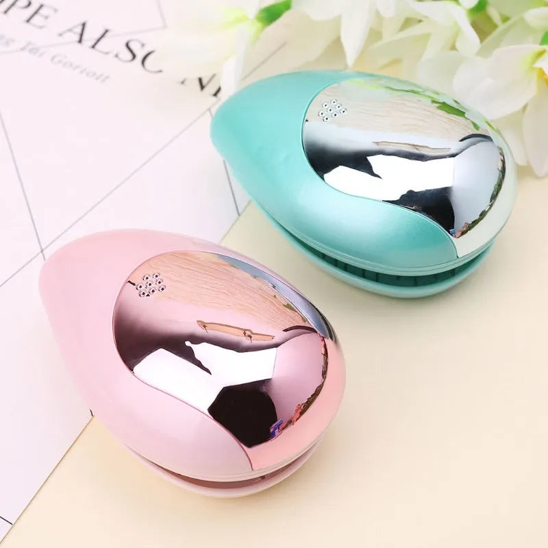 Pink electric ionic hair comb with ergonomic design on white background