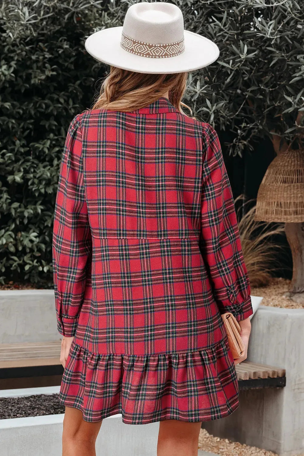 Red and black plaid women's mini dress with a shirt collar, half-button front, long sleeves, and a ruffle hem.