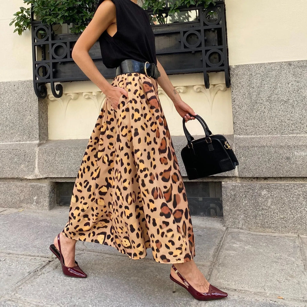 Brown leopard print women's long A-line skirt with a big hem detail on a hanger.