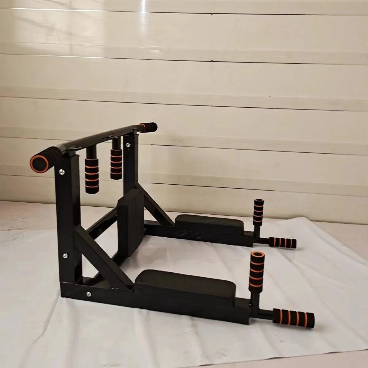 Black wall-mounted steel fitness station with sandbag rack, parallel bars and pull-up bar
