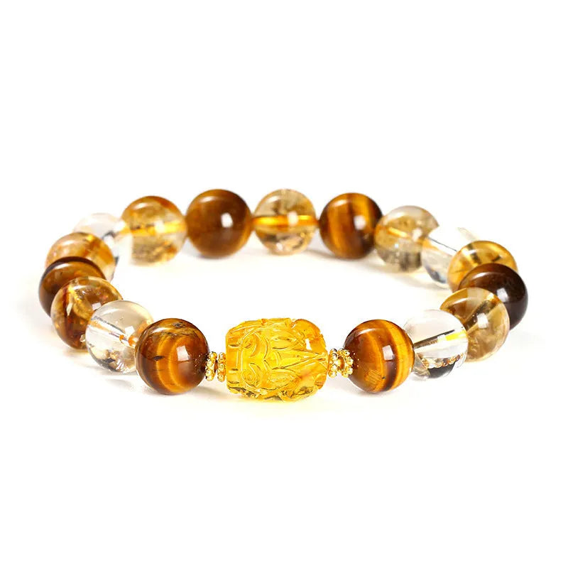 Close-up of a unisex bracelet with 10mm yellow tiger's eye and citrine round beads and a detailed beeswax pi xiu charm.