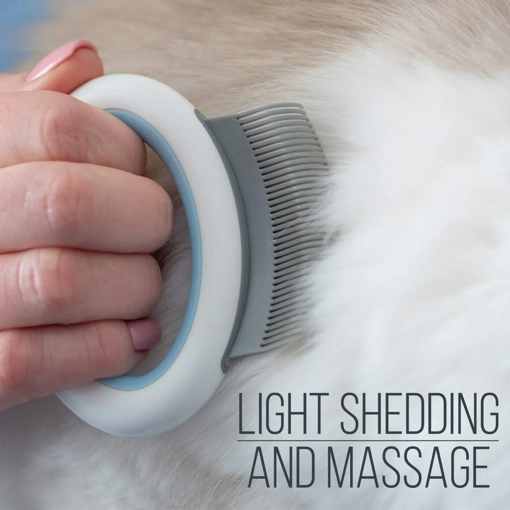 Blue pet grooming comb with ergonomic handle and soft teeth for cats and dogs on a white background.