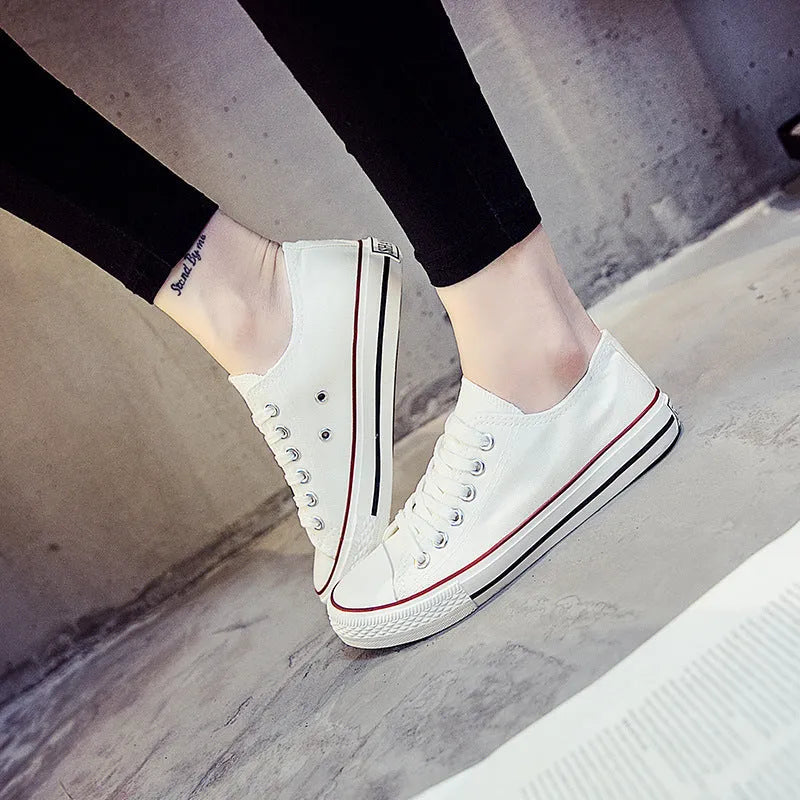 Women's solid colour canvas slip-on sneaker in black on a white background.