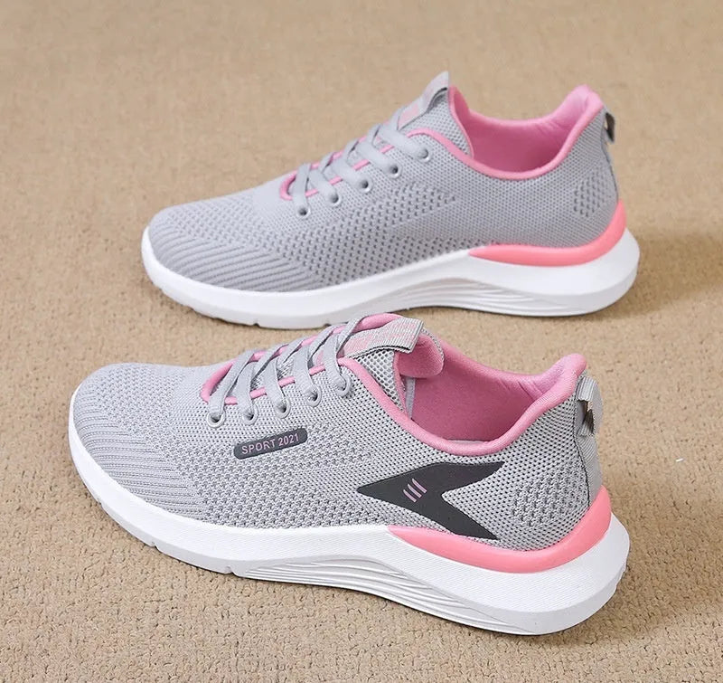 Women's low top casual running shoes in beige with mesh upper, lace-up front, round toe, and soft PVC sole