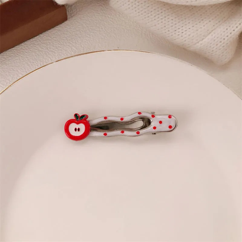 Red love heart shaped barrette hair clip with retro white dot design on black background