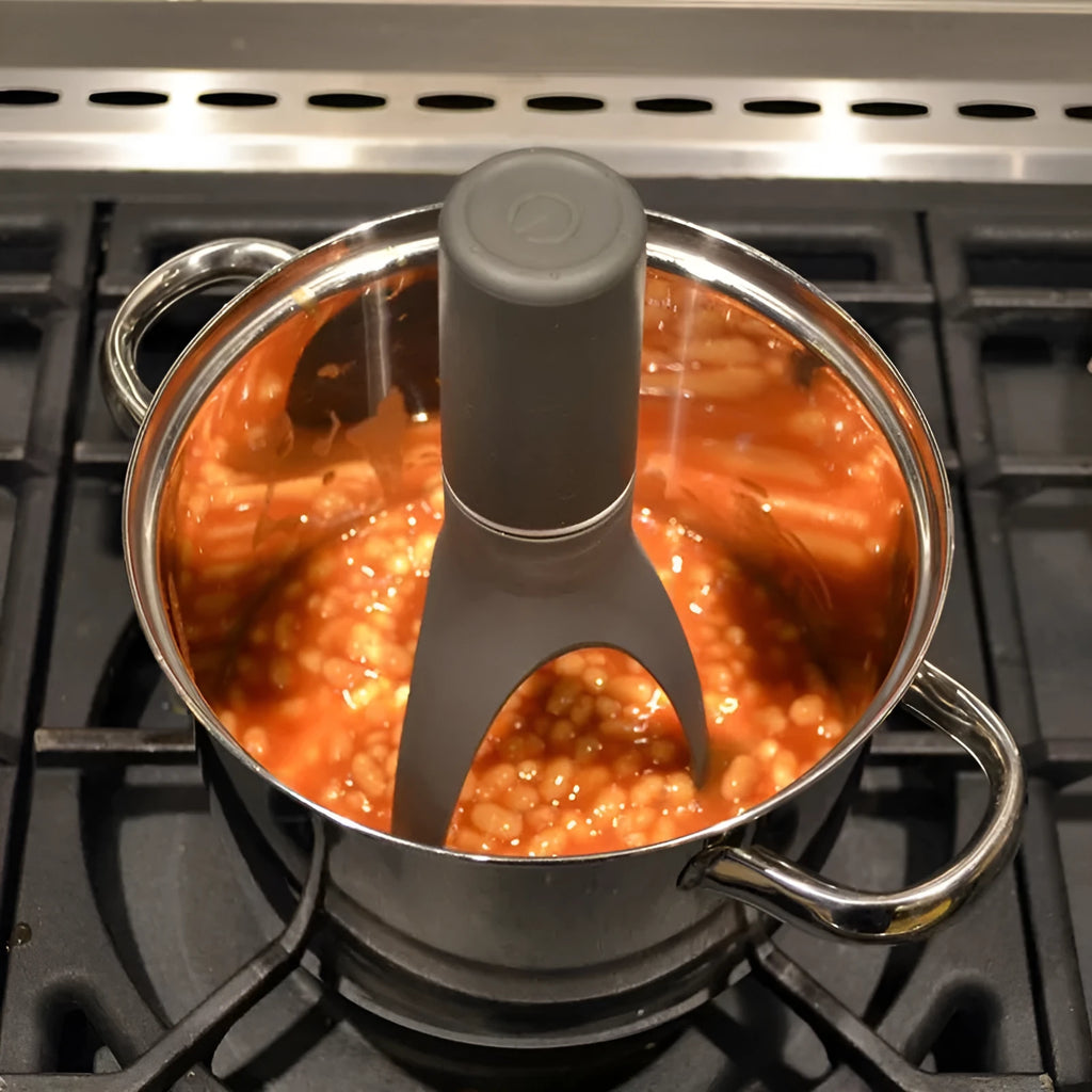 Green or grey Uutensil Stirr automatic pot mixer device for hands-free stirring of sauces and soups.