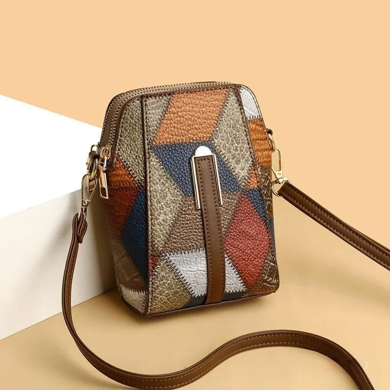 Soft PU shoulder bag with stitching detail, single strap, sandwich pocket, in irregular blue and black or blue and brown.