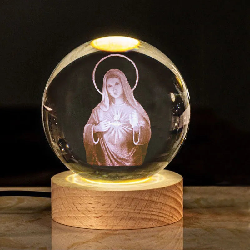 6cm white crystal ball ornament with engraved cross on a solid wood warm light base.