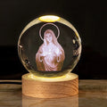 6cm white crystal ball ornament with engraved cross on a solid wood warm light base.