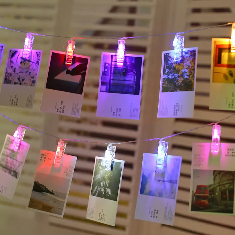 LED decorative light string with white heart-shaped clips spaced along its length, illuminated with warm white LEDs.