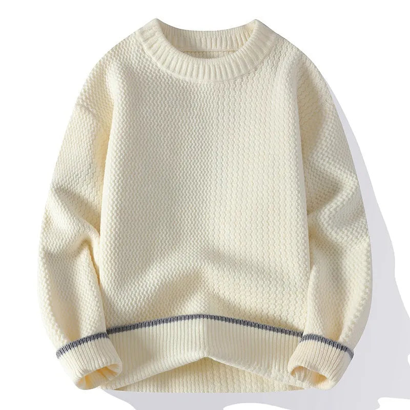 Man wearing a grey loose fit round neck long sleeve pullover sweater