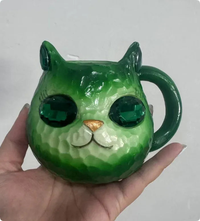 Crystal Earth globe decorative ornament on top of a colourful cat-shaped resin cup.