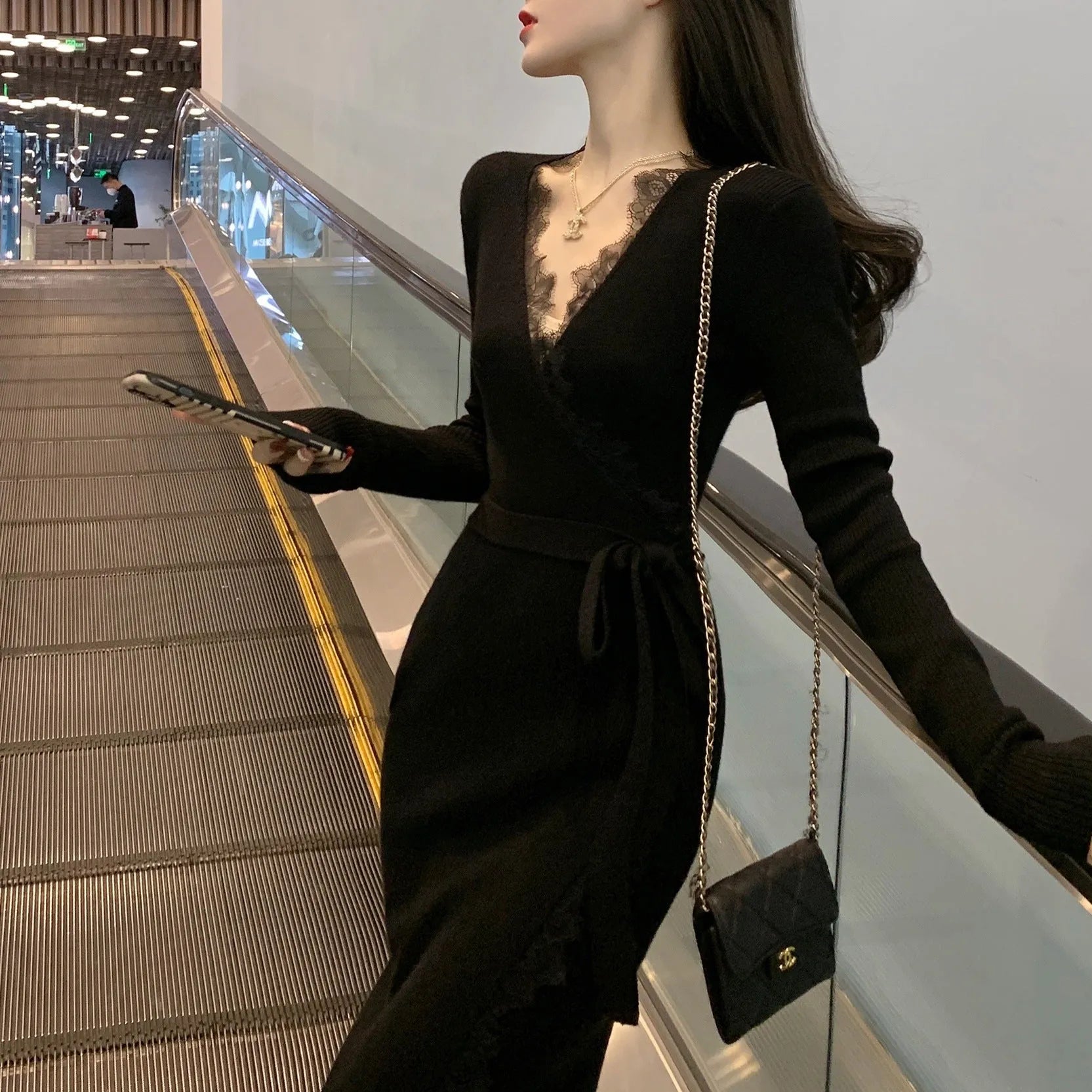 Black women's slim fit woolen skirt with a princess cut silhouette.