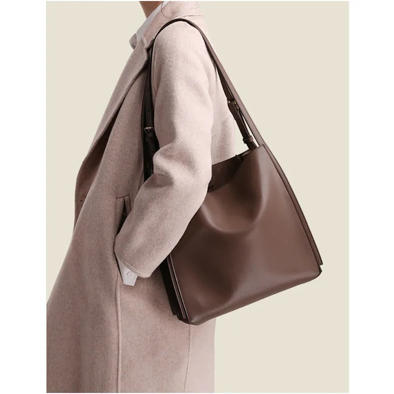 Genuine leather women's bucket bag with shoulder straps showing internal organisation compartments