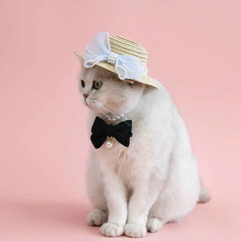 Pink pearl bow woven straw hat for a cat, shown in a princess style on a blank background.