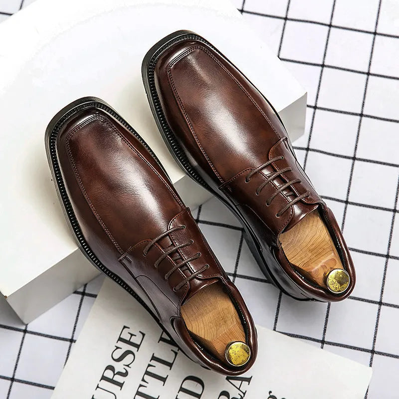 Men's black square toe business casual leather shoes with rubber sole on wooden background