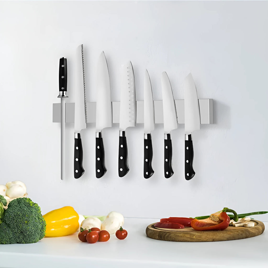 Stainless steel wall-mounted kitchen knife storage rack on white wall