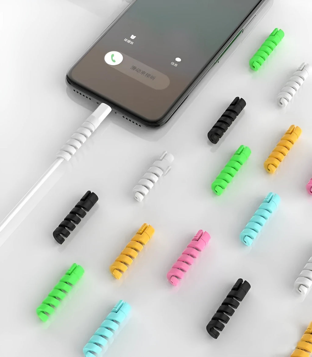 Plastic spiral charging cable protector in various colours next to a USB cable.