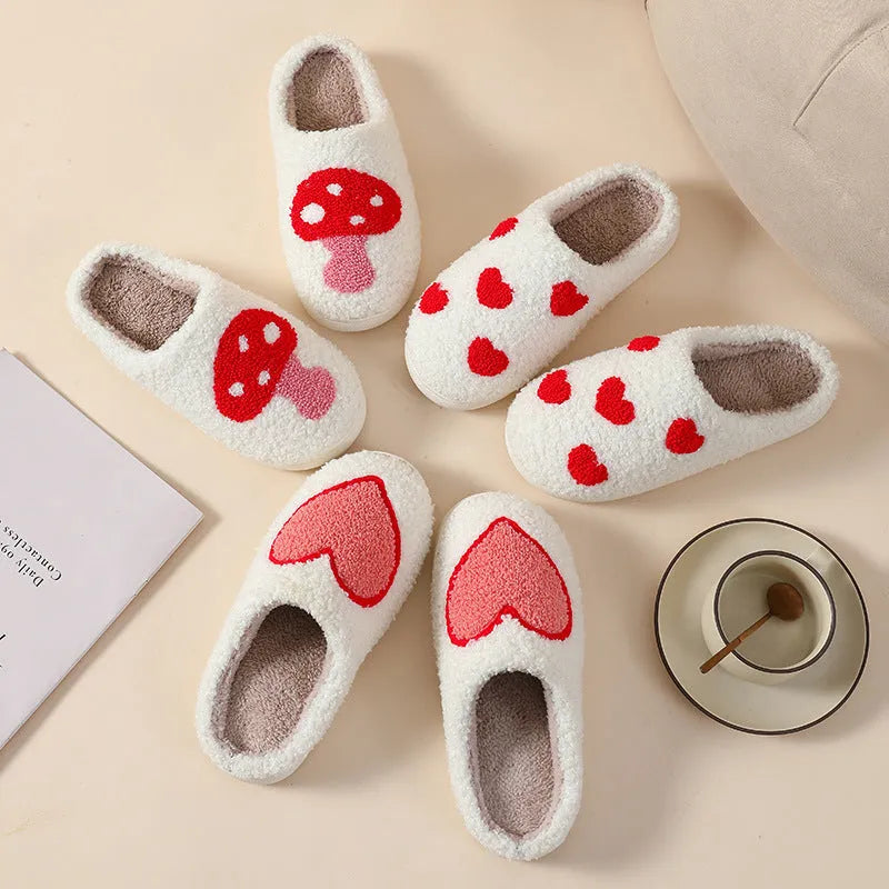 Women's plush slippers with cartoon love design, showing round toe and non-slip PVC sole.