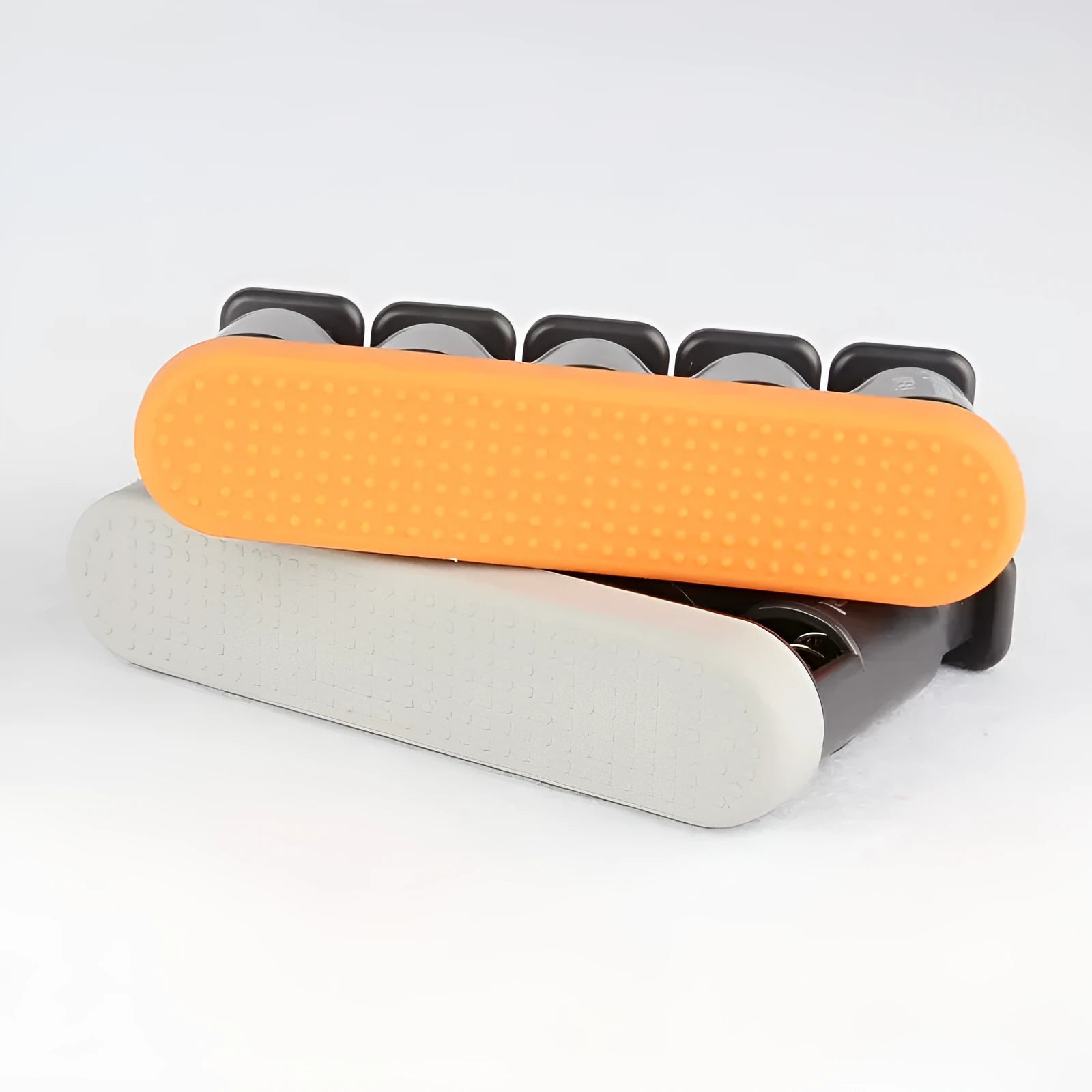 Grey silicone climbing fingerboard-style hand trainer for musician finger strength exercises.