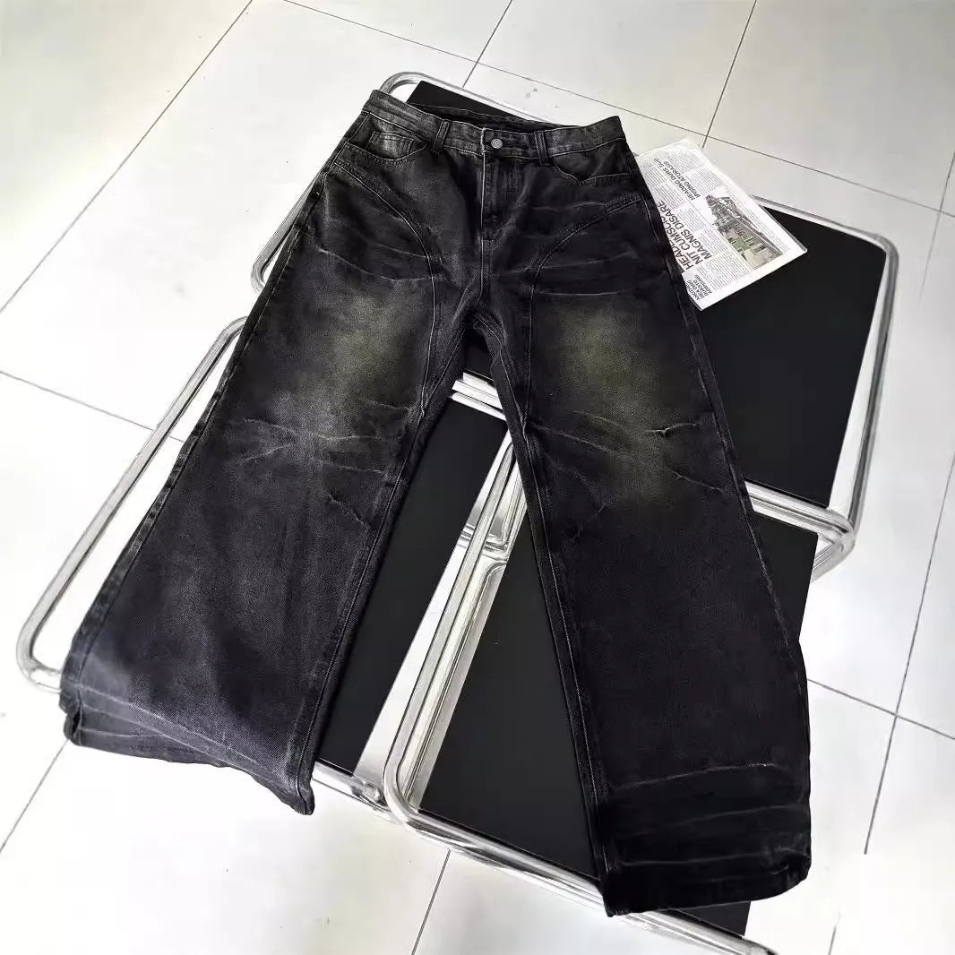 Mens washed black straight leg denim jeans with dirty mud texture and zip fly