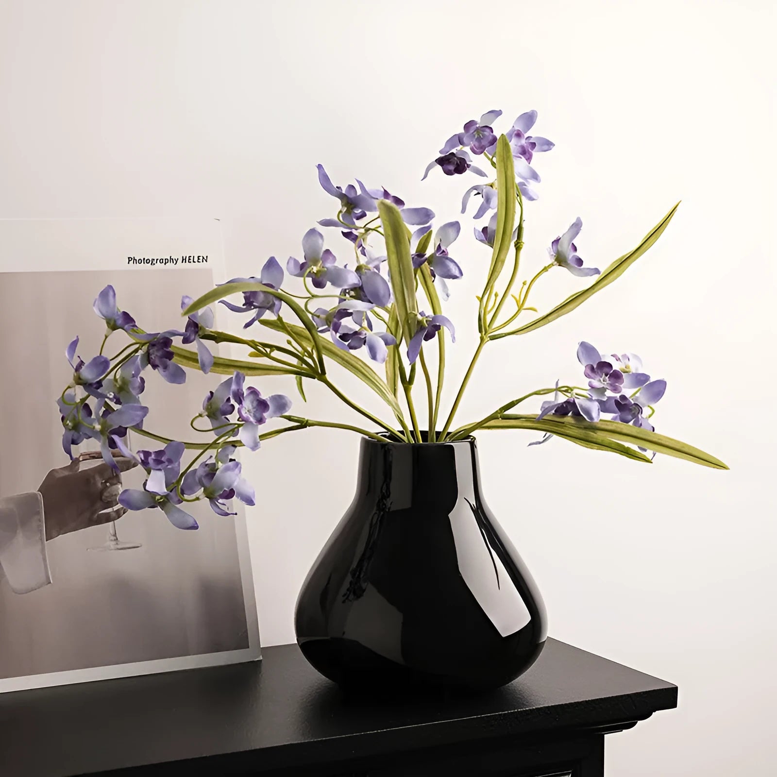 Ceramic round belly vase with coloured glaze finish and two orchid flowers in modern simplicity design