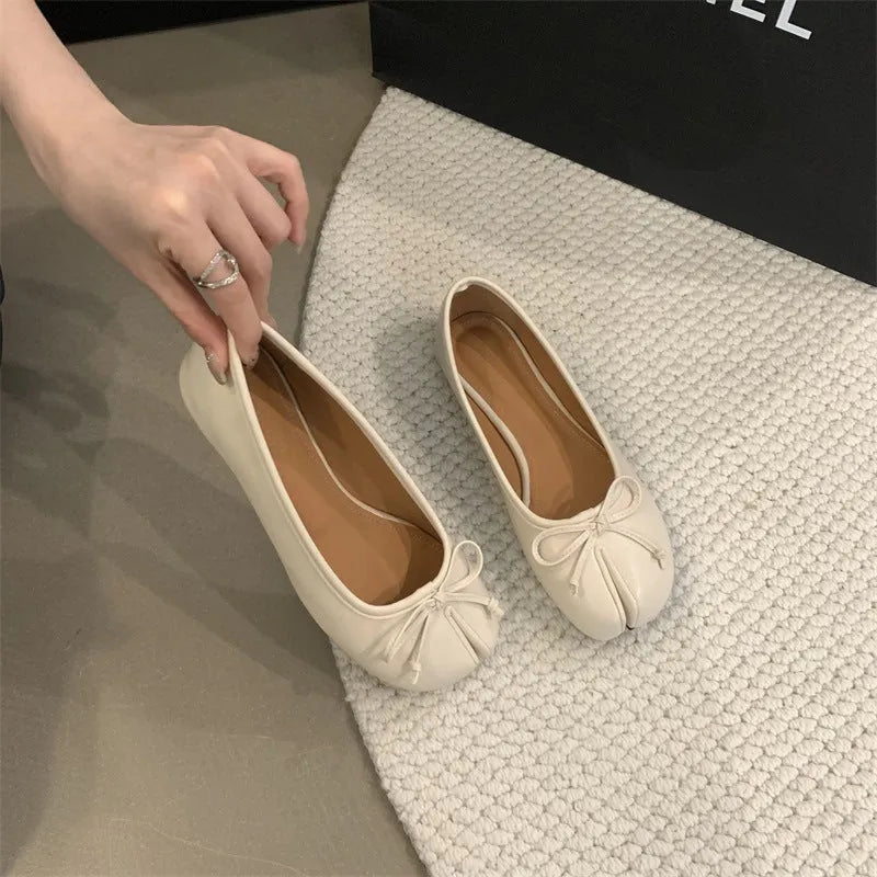 Women's flat split-toe pumps in black, silver, beige, and red with an oversleeve design.