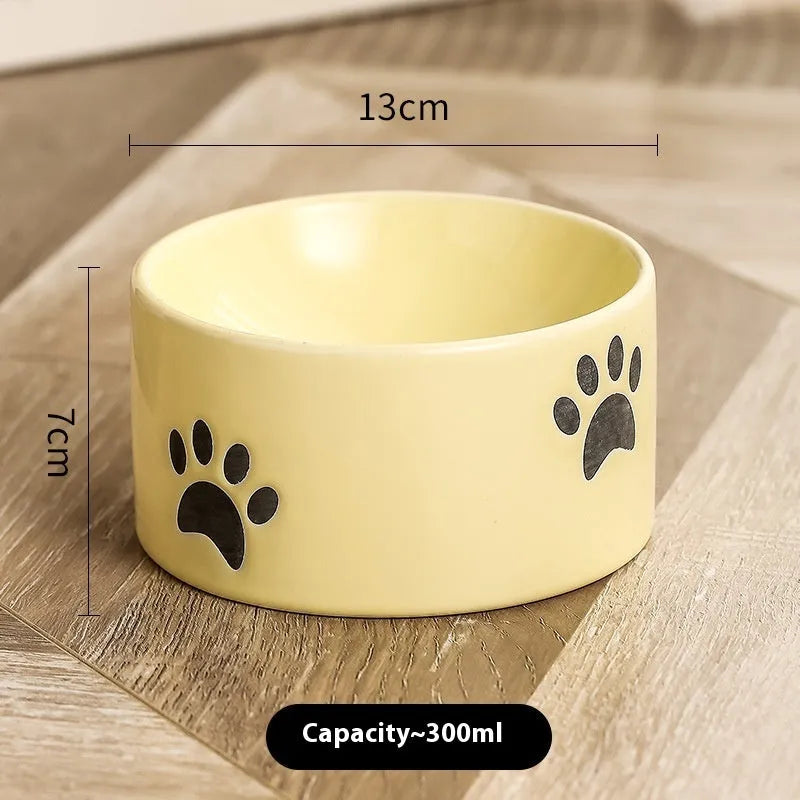 Ceramic high foot cat food bowl with cat paw print decoration in chosen colour