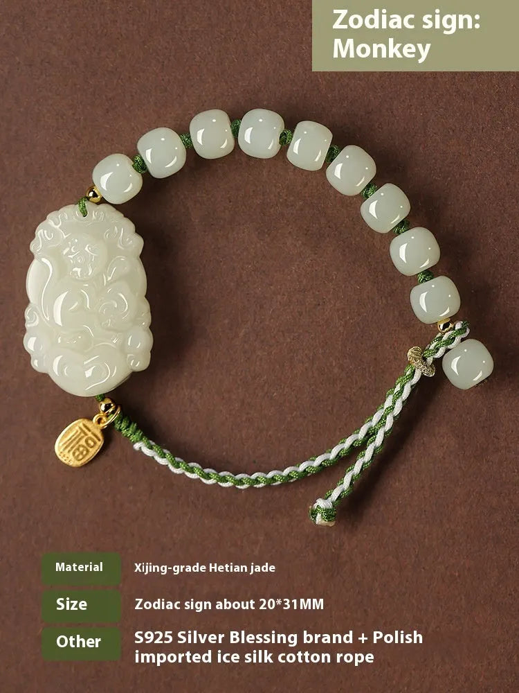 Year of the Rabbit Hetian jade charm bracelet with S925 silver detailing on a red cotton rope.