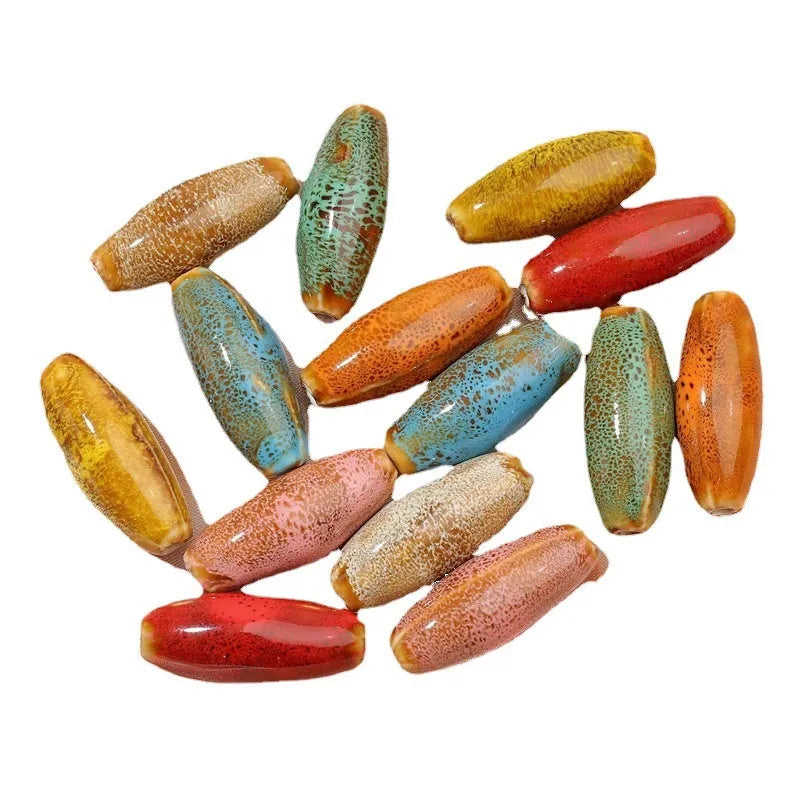 Ten ceramic bullet beads with a glazed finish arranged together, showing assorted colour options.