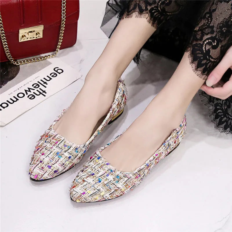 Women's black and white canvas flats with flower pattern, pointed toe, and low-cut design