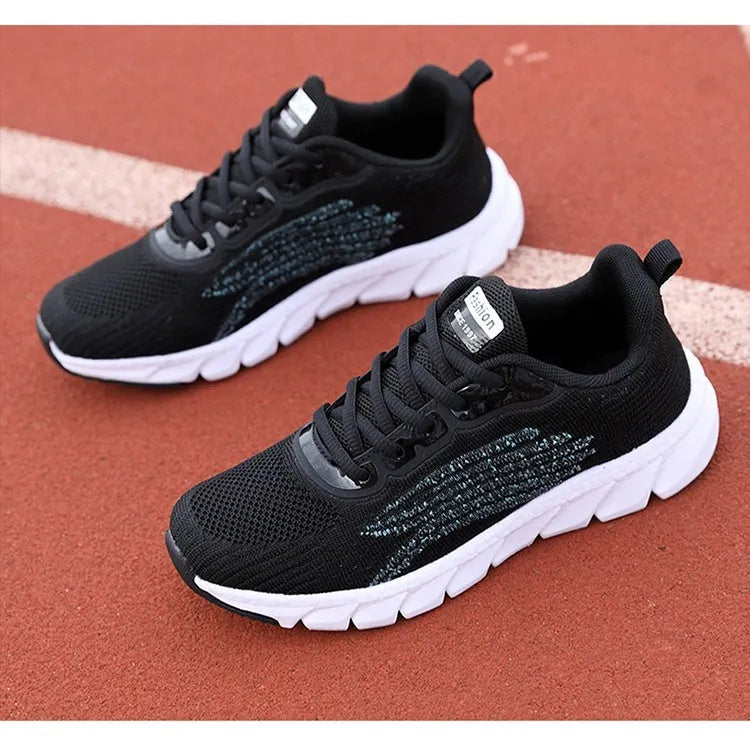 Women's low-top black and white running sneakers with cross-strap detail and MD sole.